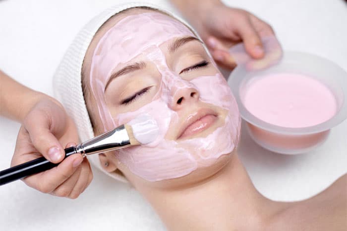 Pink cream mask applied during a facial